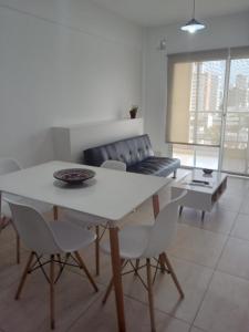 a living room with a table and a couch at Departamento macrocentro Santa Fe in Santa Fe