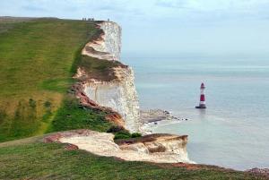 a lighthouse on top of a cliff next to the ocean at The Berkeley Guesthouse in Eastbourne
