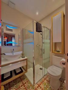 a bathroom with a toilet and a sink and a shower at Chambres d'Hôtes Le Mimosa in Saint-Saturnin-de-Lucian +203 photos