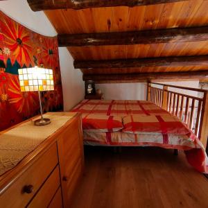 a bedroom with a bed and a wooden ceiling at Cabaña de Madera el Roserar Parque Natural de Montseny in Montseny