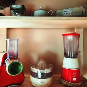 a red blender sitting on top of a shelf at Cabaña de Madera el Roserar Parque Natural de Montseny in Montseny +28 photos