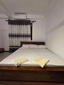 Ένα ή περισσότερα κρεβάτια σε δωμάτιο στο Sky Bloom Homagama