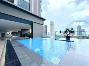a swimming pool on the roof of a building at SKS Pavillion Residences - High Floor with Singapore View in Johor Bahru