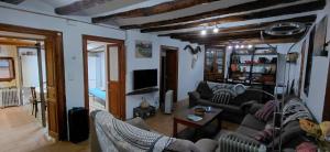 a living room with two couches and a tv at Can Manuel in Gabet