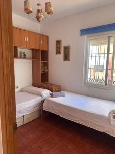 Ένα ή περισσότερα κρεβάτια σε δωμάτιο στο Villa Natalia frente al mar,