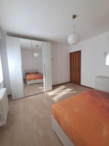 a bedroom with an orange bed and a mirror at Dimora Antico Forno  +9 photos