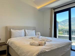 a bedroom with a large bed with a large window at Salam Residence 2 - Ladies-Only Pool & Family Pools in Alanya +149 photos