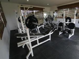 a gym with a bunch of tread machines in it at Pousada Villas da Serra in Serra de São Bento