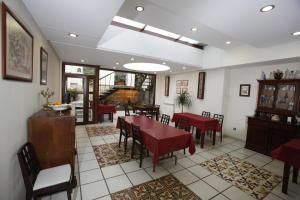 a dining room with red tables and chairs at Hostal Rey Pedro I in Santo Domingo de la Calzada