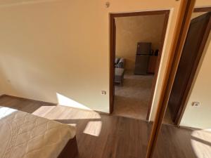 a bedroom with a door leading to a living room at Apartment 24 in Pamporovo