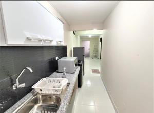 a kitchen with a sink and a counter top at Amaca Hostal in Santa Cruz de la Sierra