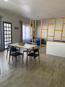 a room with a table and chairs and a bed at Dpto pura vida 3 in General Roca