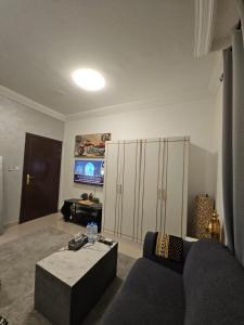a living room with a couch and a coffee table at Studio towam hospital 2 in Al Ain