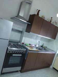 a kitchen with a stove and a sink at Appartamento Beatrice in Pistoia +7 photos