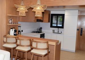 a kitchen with a table and chairs and a counter at duplex bord de mer résidence restinga smir in Restinga Smir