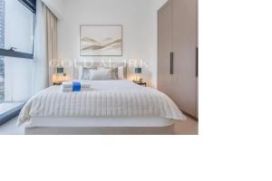a bedroom with a white bed and a window at Stunning One bed Dubai mall downtown in Dubai +26 photos