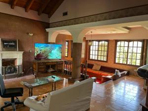 a living room with a couch and a tv at SWEET HOME PATAGONIA in Comodoro Rivadavia