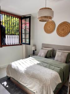 a bedroom with a bed and a window at Buganvilla Garden Puerto de la Cruz in Puerto de la Cruz