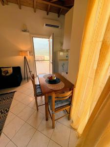 a table and chair in a room with a kitchen at Eva's Apartments in Karlovasi