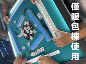 a group of people standing around a table playing a game at Blue Sea and Sunny B&B in Toucheng