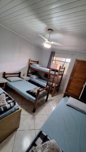 a room with three beds and a ceiling at Hostel My House quartos perto do aeroporto de Guarulhos in Guarulhos +69 photos