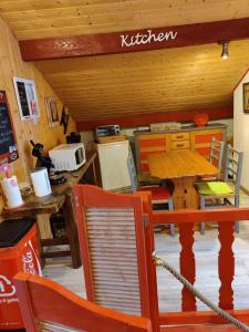 a kitchen with a table and chairs in a room at Cocon Nature in La Bourgonce +14 photos