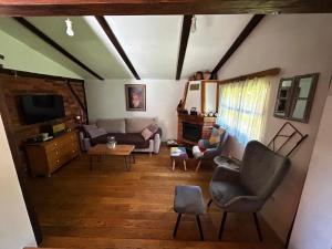 a living room with a couch and a chair at Dorina hiža in Karlovac