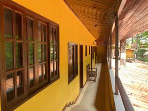 an empty hallway of a building with windows at Lonier Villa Inn Economic in Abraão