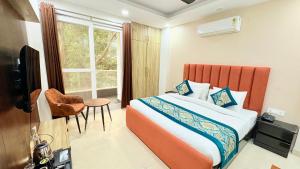 a hotel room with a bed and a window at The Nuvon Residency CR Park in New Delhi