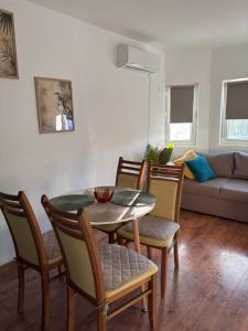 a living room with a table and chairs and a couch at White House Apartments - Forest in Haskovo