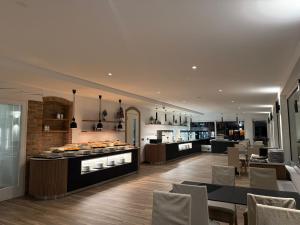 a kitchen and dining room with tables and chairs at Hotel Giada Viale del Sole in Vicenza