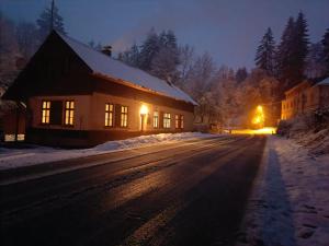 a house on the side of a snow covered road at Chalupa u Jizery in Rokytnice nad Jizerou