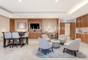 a living room with a table and chairs and a kitchen at Stunning One bed Dubai mall downtown in Dubai