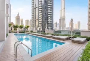 an apartment with a swimming pool on the roof of a building at Stunning One bed Dubai mall downtown in Dubai