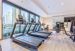 a gym with treadmills and exercise equipment in a building at Stunning One bed Dubai mall downtown in Dubai