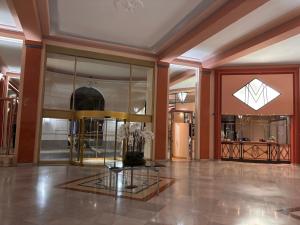 a lobby with a glass table in a building at Boulevard de la croisette PALAIS MIRAMAR in Cannes