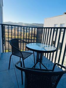 a table and two chairs on a balcony with a view at Rumia Apartment by JumpInHere in Rumia +1 photo