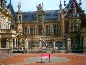 a large building with a sign in front of it at Les Galets in Fécamp