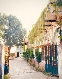 a building with a fence with colorful flags on it at Khurja Wali Dharamshala in Rishīkesh
