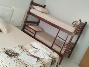 a bedroom with a bunk bed and a chair at Hotel Vitória - Guaíra in Guaíra +70 photos
