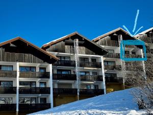a building on top of a snow covered hill at FeWo Bergruh 922 im Ferienpark Oberallgäu in Missen-Wilhams