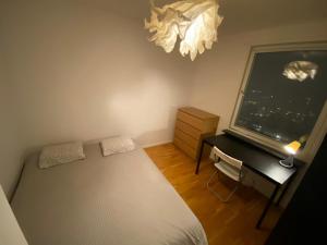 a bedroom with a bed and a desk and a window at Wesfield Private in Solna +8 photos