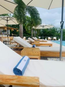a towel sitting on top of a bed next to a pool at Villa Francia in San Juan del Sur