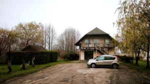 a car parked in front of a house at Jaunrūtiņas dīķis in Salaspils