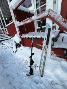 a couple of cats sitting on a snow covered porch at Two bedroom duplex with peaceful views in Jyväskylä