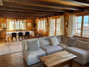 a living room with a couch and a table at Chalet familial Rose de Noël in Les Diablerets