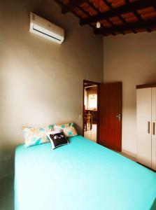 una camera da letto con un letto blu e un cappello sopra di Canto Sereno Refúgio entre Praias e Ilhas a Parati Altre 19 foto