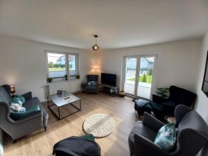 a living room with couches and chairs and a tv at Cityhouse Lubliniec 4 Bedrooms, Garden, Parking, Business & Family in Lubliniec
