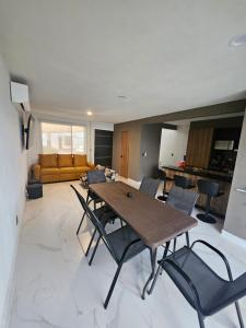 a living room with a wooden table and chairs at DAGA House Pool table, pool and air conditioning in Alpuyeca
