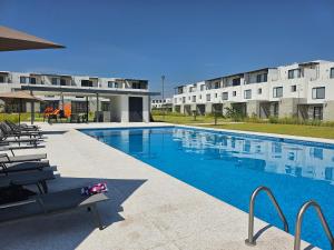 a swimming pool in front of a building at DAGA House Pool table, pool and air conditioning in Alpuyeca